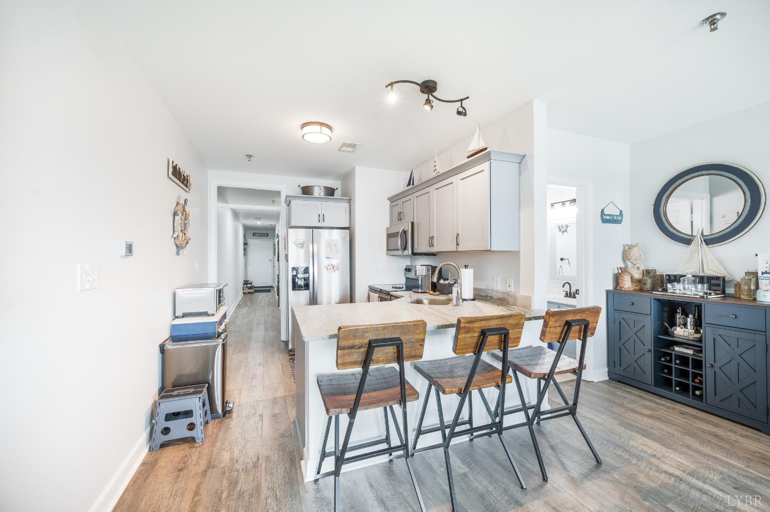 1245 Graves Harbor Trail, Unit 212 Huddleston, VA 24104 - Photo 22 of 60 a view of a dining room with furniture and wooden floor