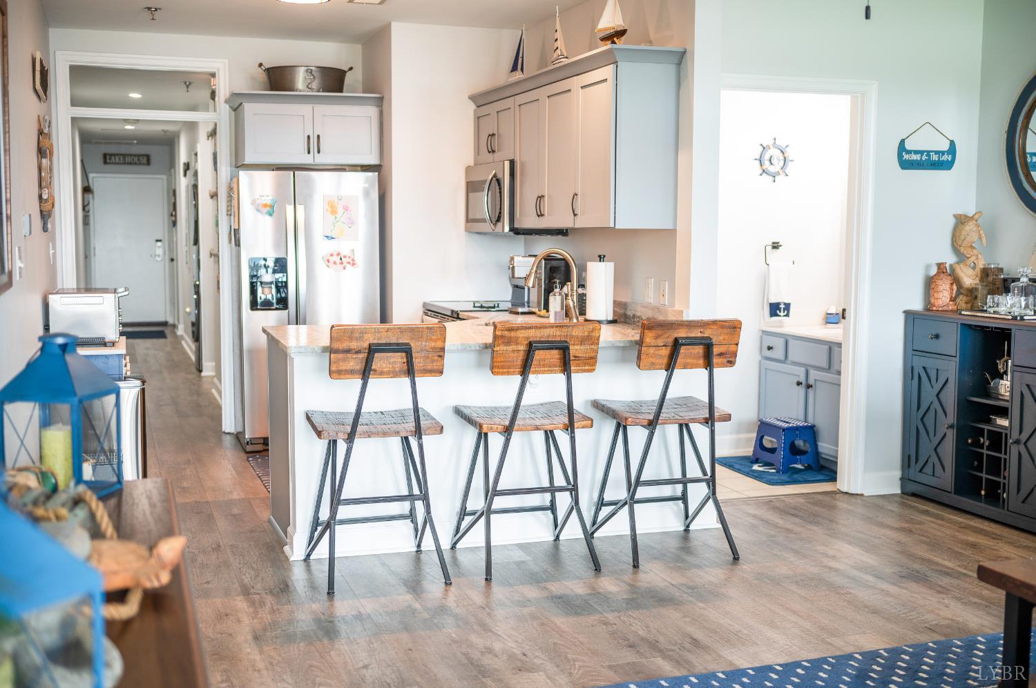 1245 Graves Harbor Trail, Unit 212 Huddleston, VA 24104 - Photo 26 of 60 a view of a dining room with furniture and wooden floor