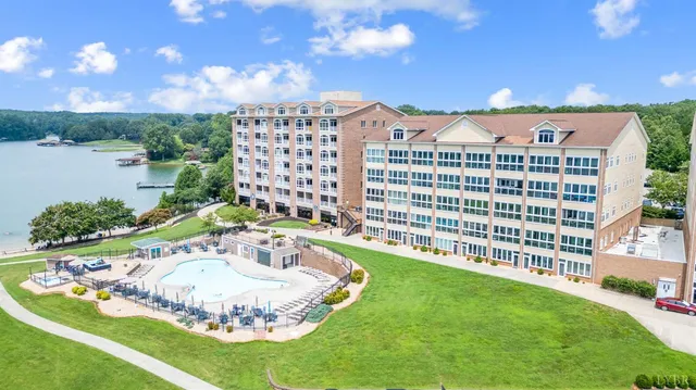 a view of a swimming pool with a yard and plants