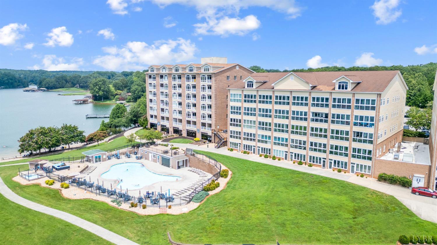 1245 Graves Harbor Trail, Unit 212 Huddleston, VA 24104 - Photo 3 of 60 a view of a swimming pool with a yard and plants