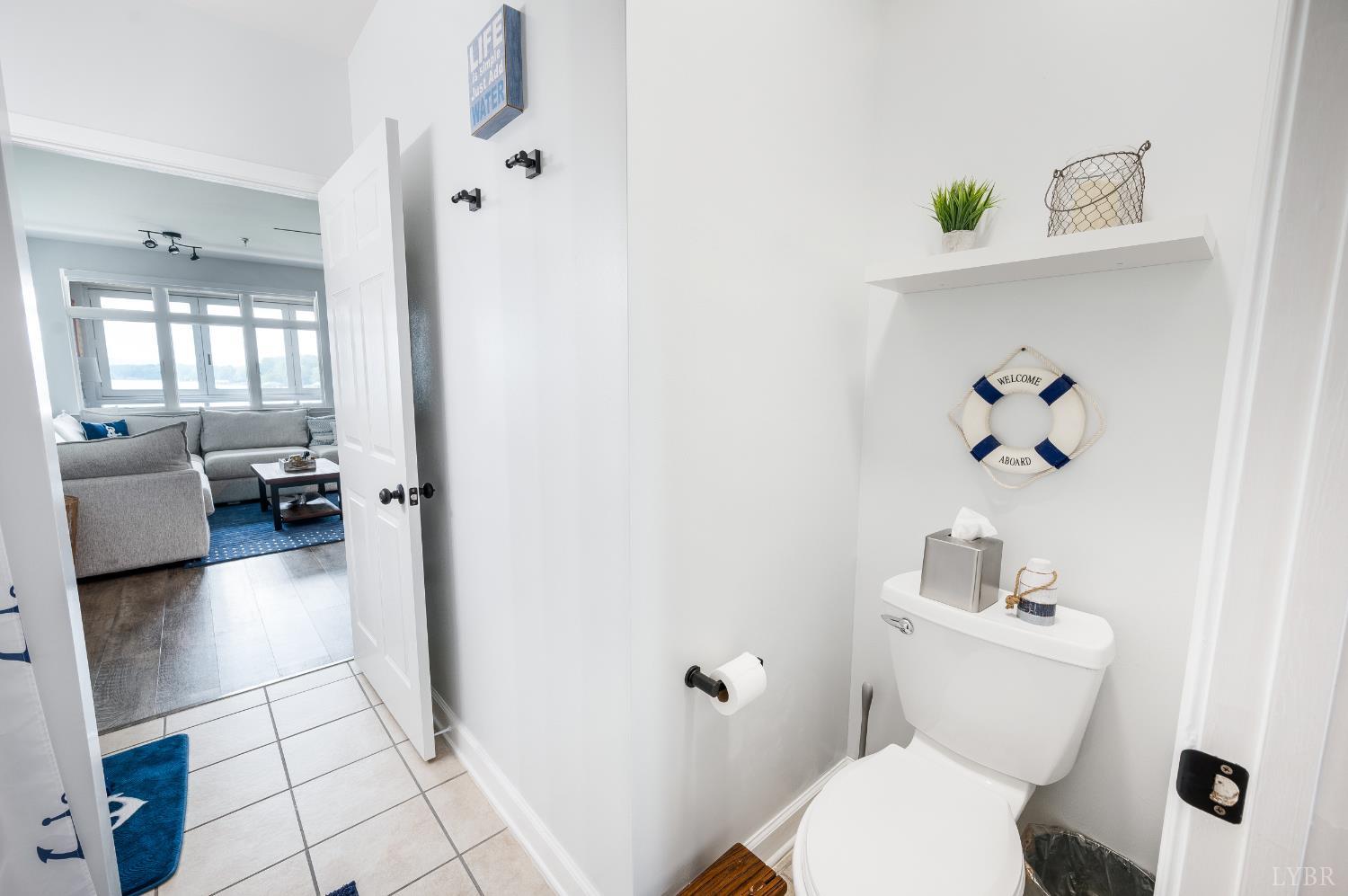 1245 Graves Harbor Trail, Unit 212 Huddleston, VA 24104 - Photo 36 of 60 a bathroom with a toilet sink and mirror