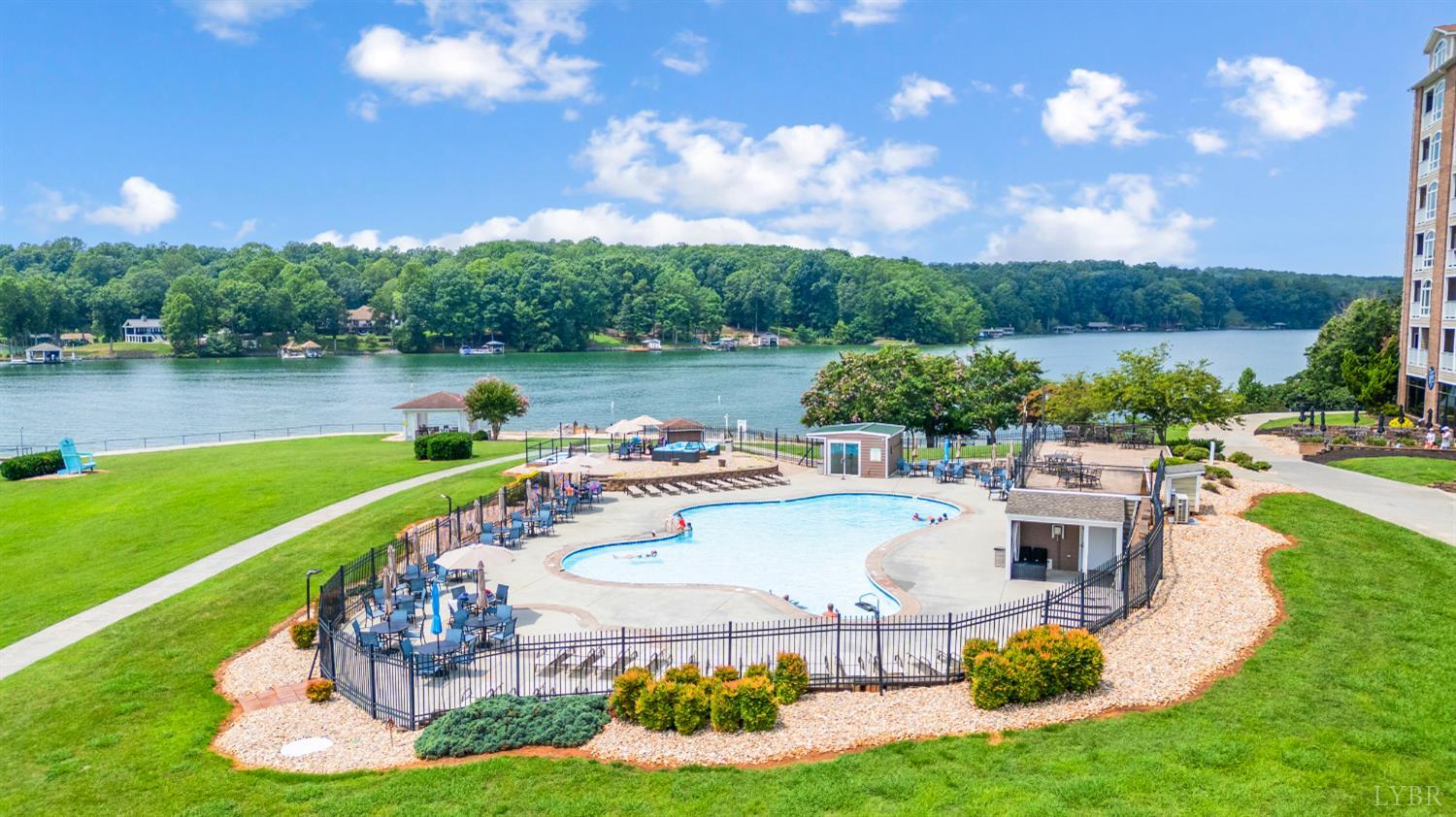 1245 Graves Harbor Trail, Unit 212 Huddleston, VA 24104 - Photo 43 of 60 a view of a lake with a garden and houses
