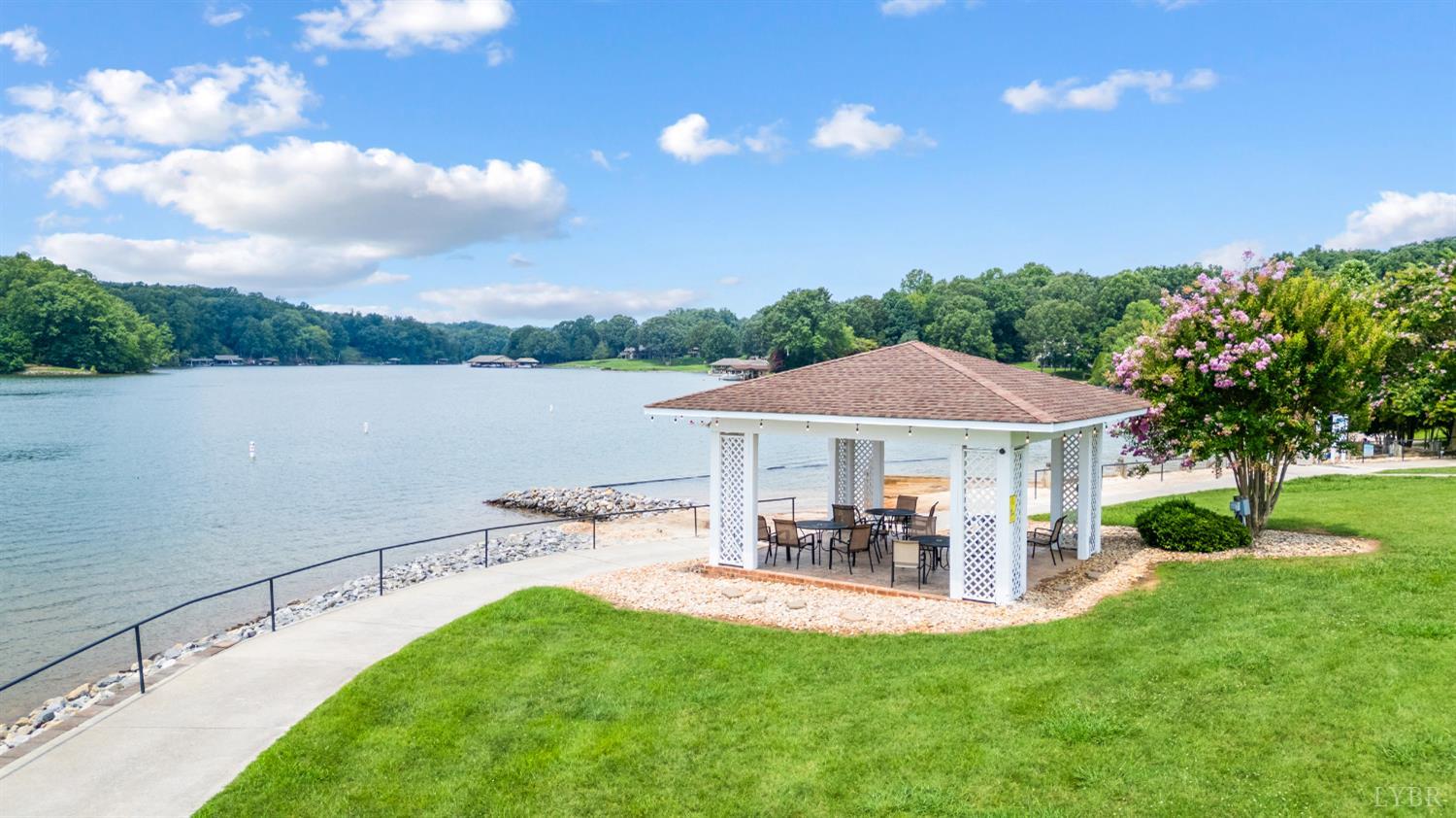1245 Graves Harbor Trail, Unit 212 Huddleston, VA 24104 - Photo 48 of 60 a view of a patio with table and chairs under an umbrella