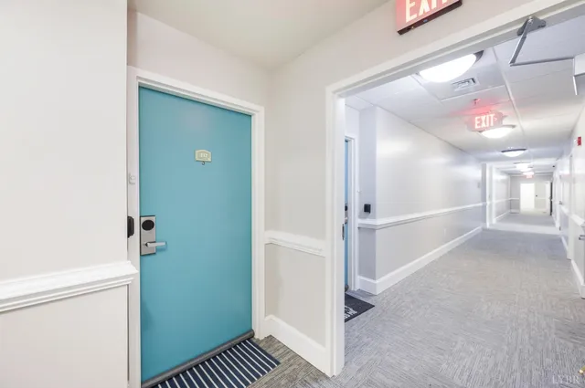 a view of a hallway view with wooden floor and staircase