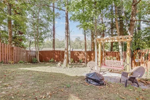 a backyard of a house with table and chairs