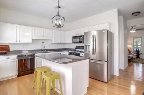 a kitchen with a refrigerator a sink and a stove