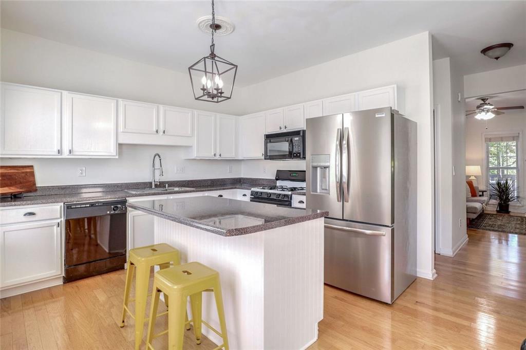 1622 Indian Way Cumming, GA 30040 - Photo 8 of 22 a kitchen with a refrigerator a sink and a stove