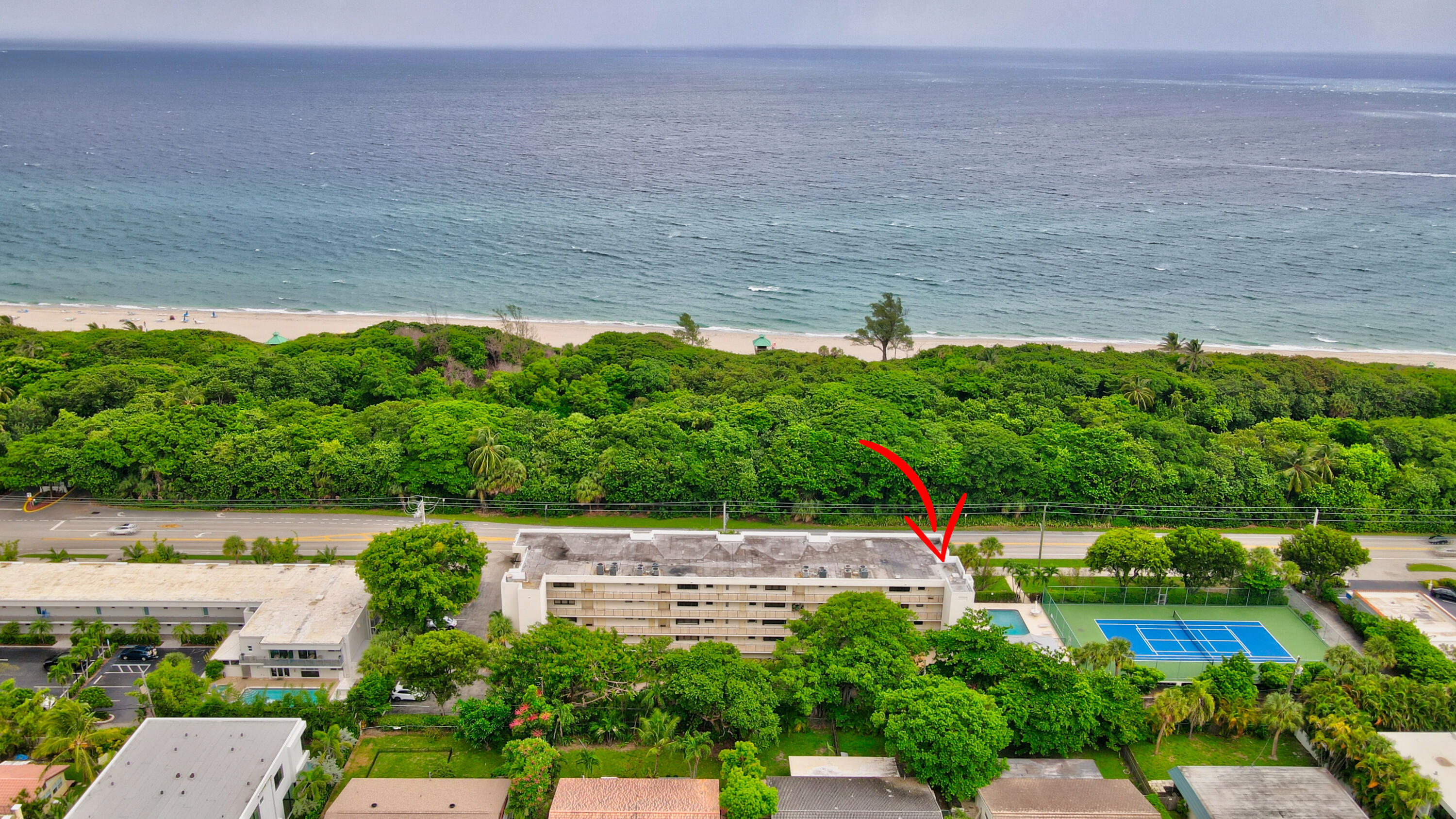 a aerial view of a house with a yard and lake view