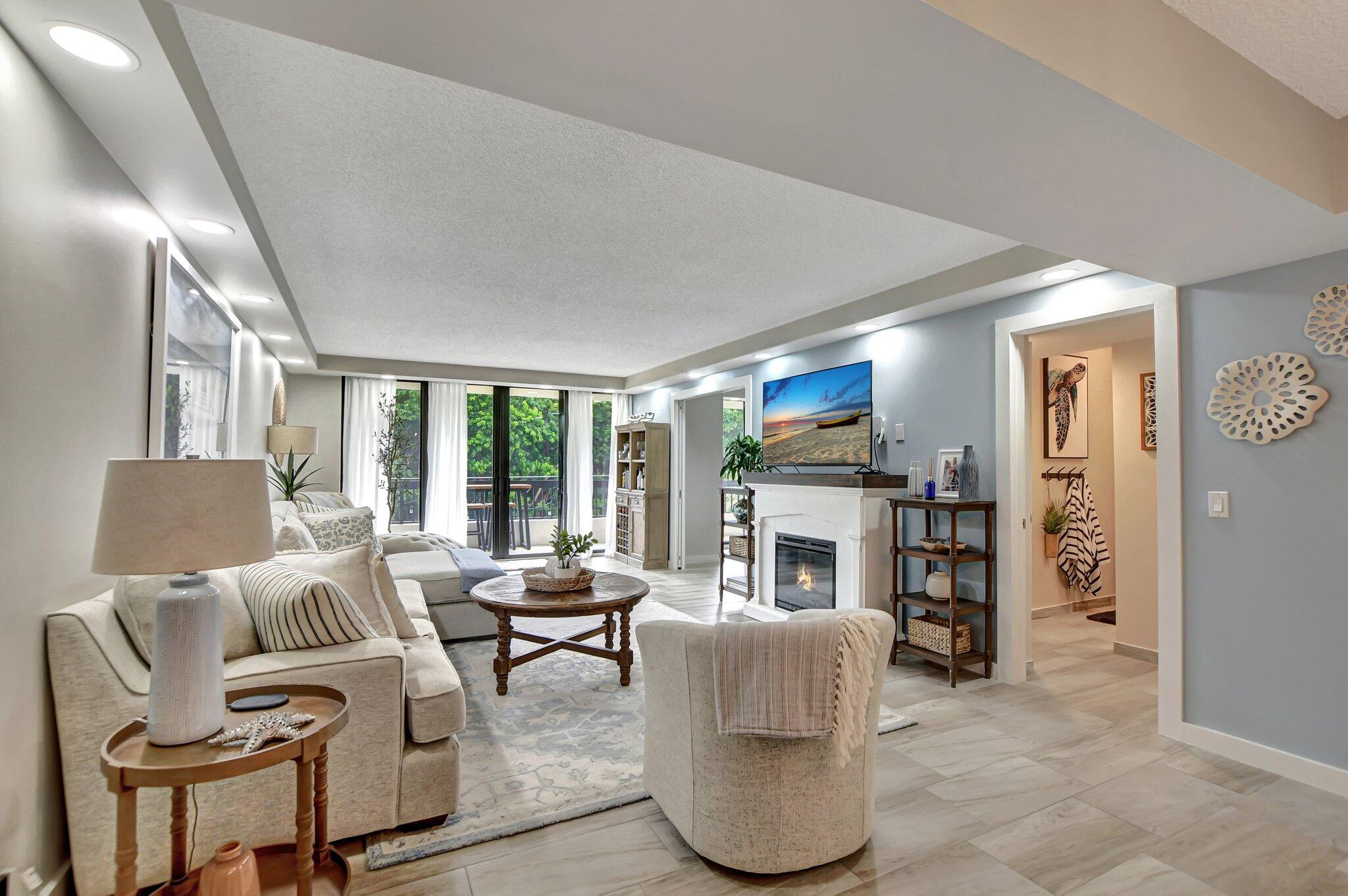 277 North Ocean Boulevard, Unit 3010 Boca Raton, FL 33432 - Photo 12 of 37 a living room with furniture and a fireplace