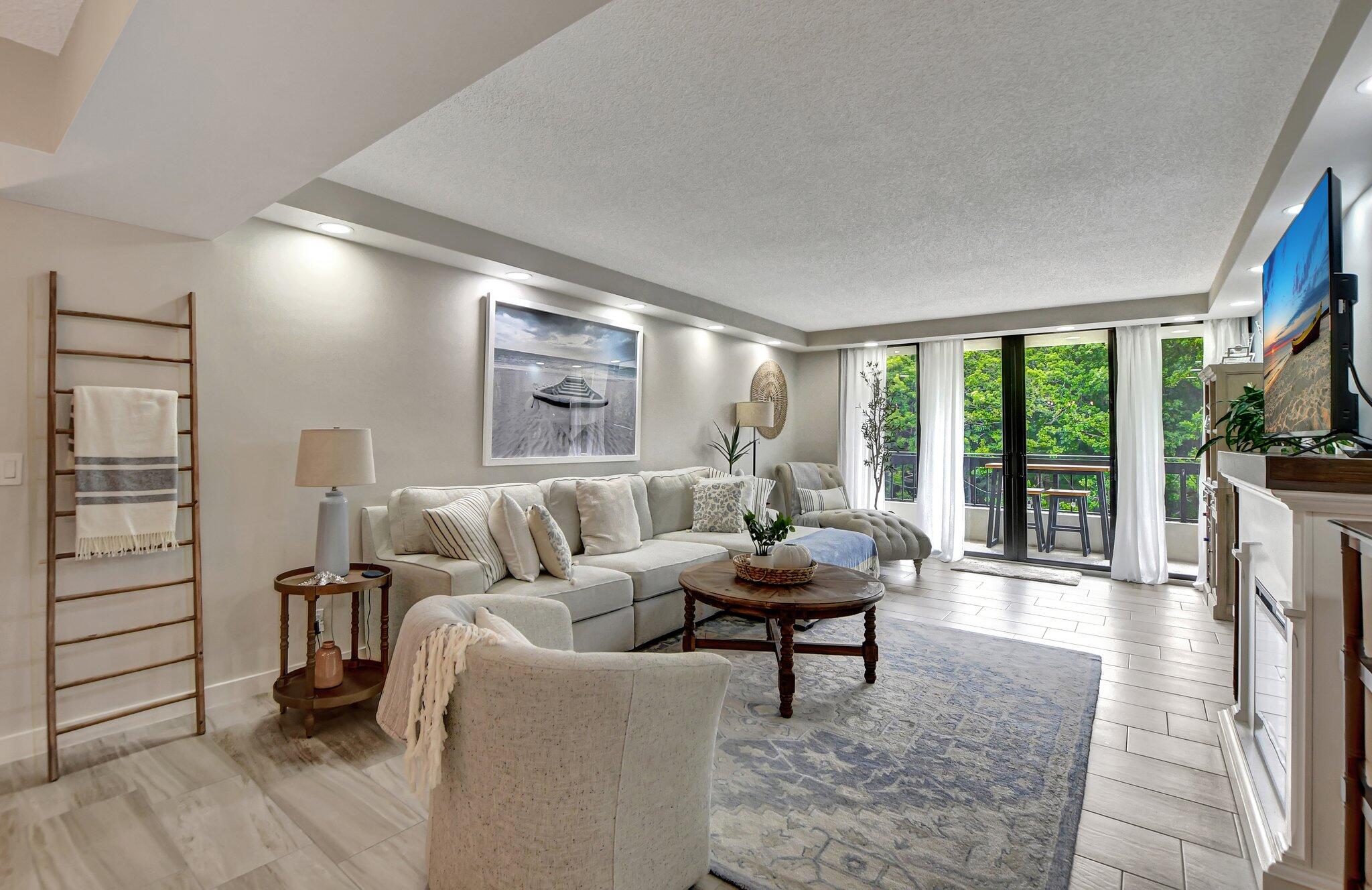 277 North Ocean Boulevard, Unit 3010 Boca Raton, FL 33432 - Photo 13 of 37 a living room with furniture and a floor to ceiling window