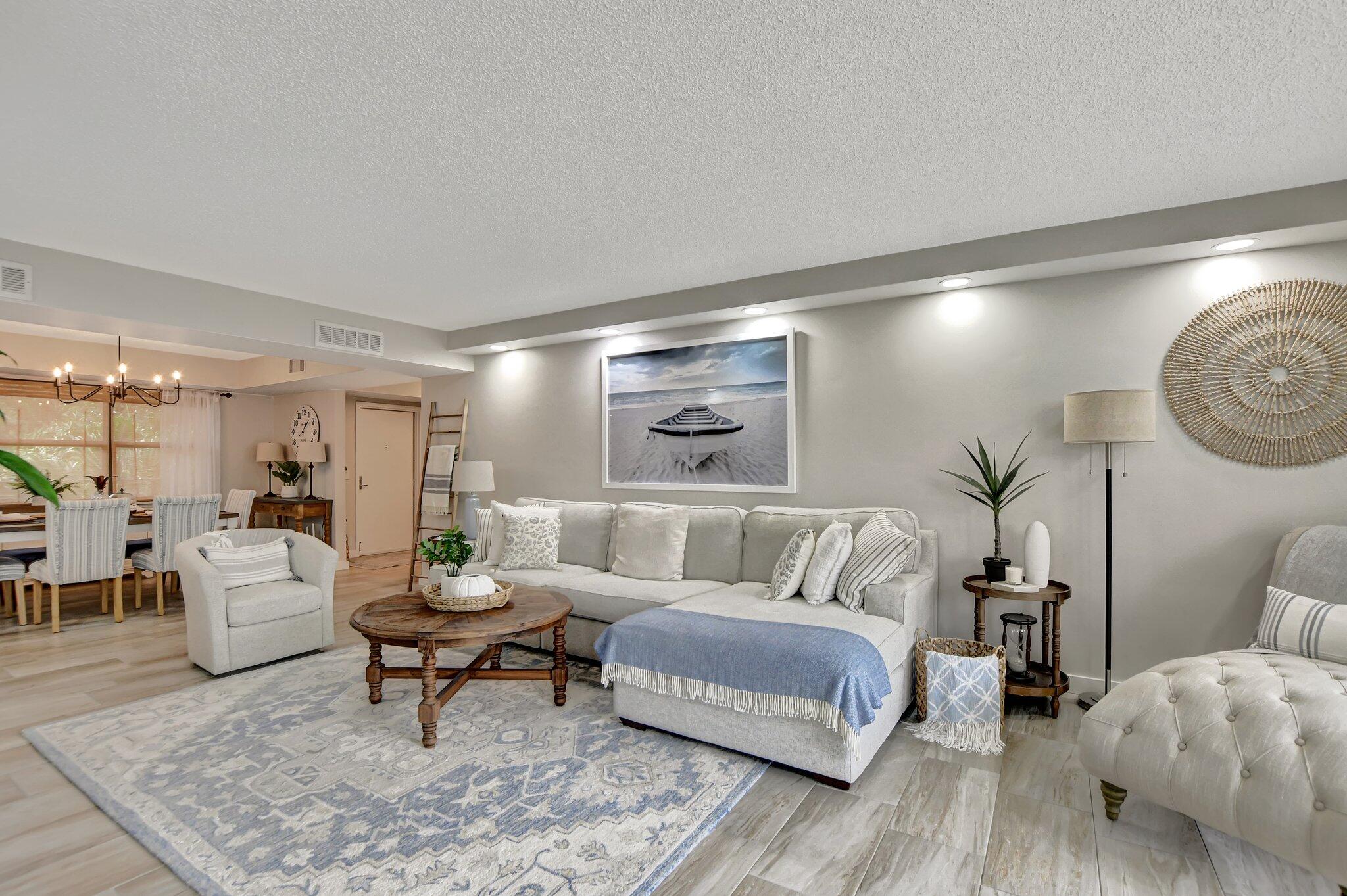 277 North Ocean Boulevard, Unit 3010 Boca Raton, FL 33432 - Photo 14 of 37 a living room with furniture and a rug