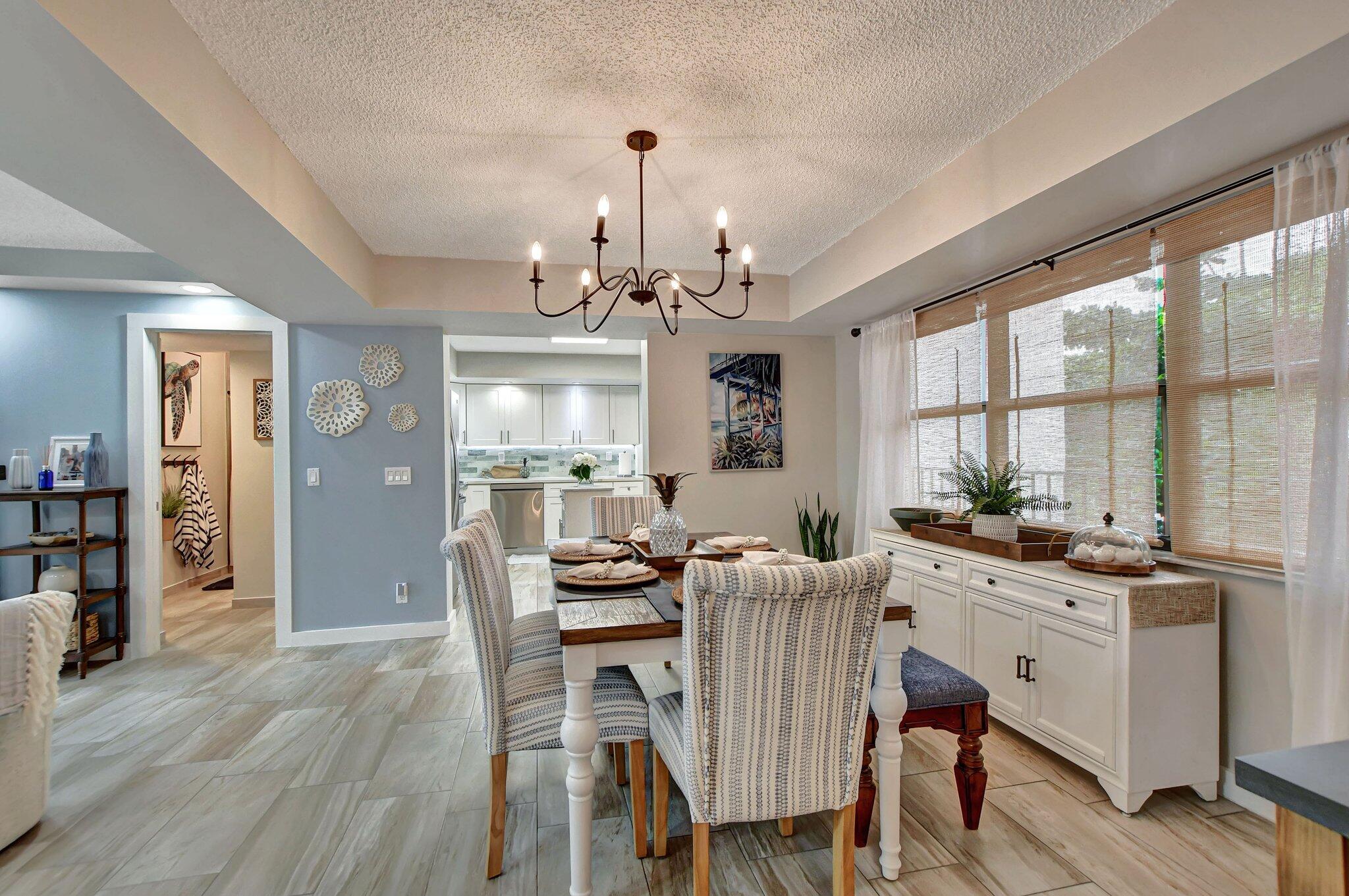 277 North Ocean Boulevard, Unit 3010 Boca Raton, FL 33432 - Photo 17 of 37 a view of a dining room with furniture window and wooden floor