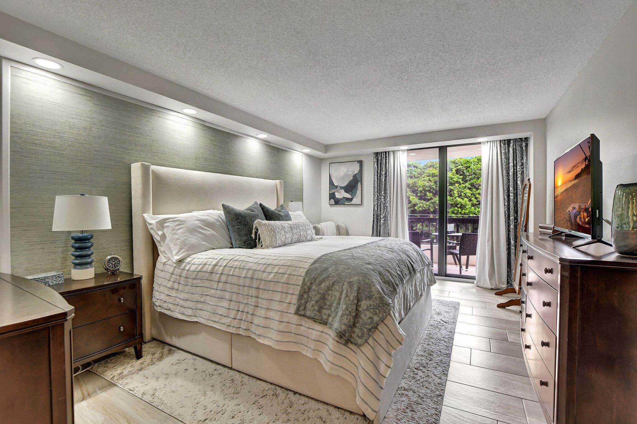 277 North Ocean Boulevard, Unit 3010 Boca Raton, FL 33432 - Photo 22 of 37 a bedroom with a bed and large window