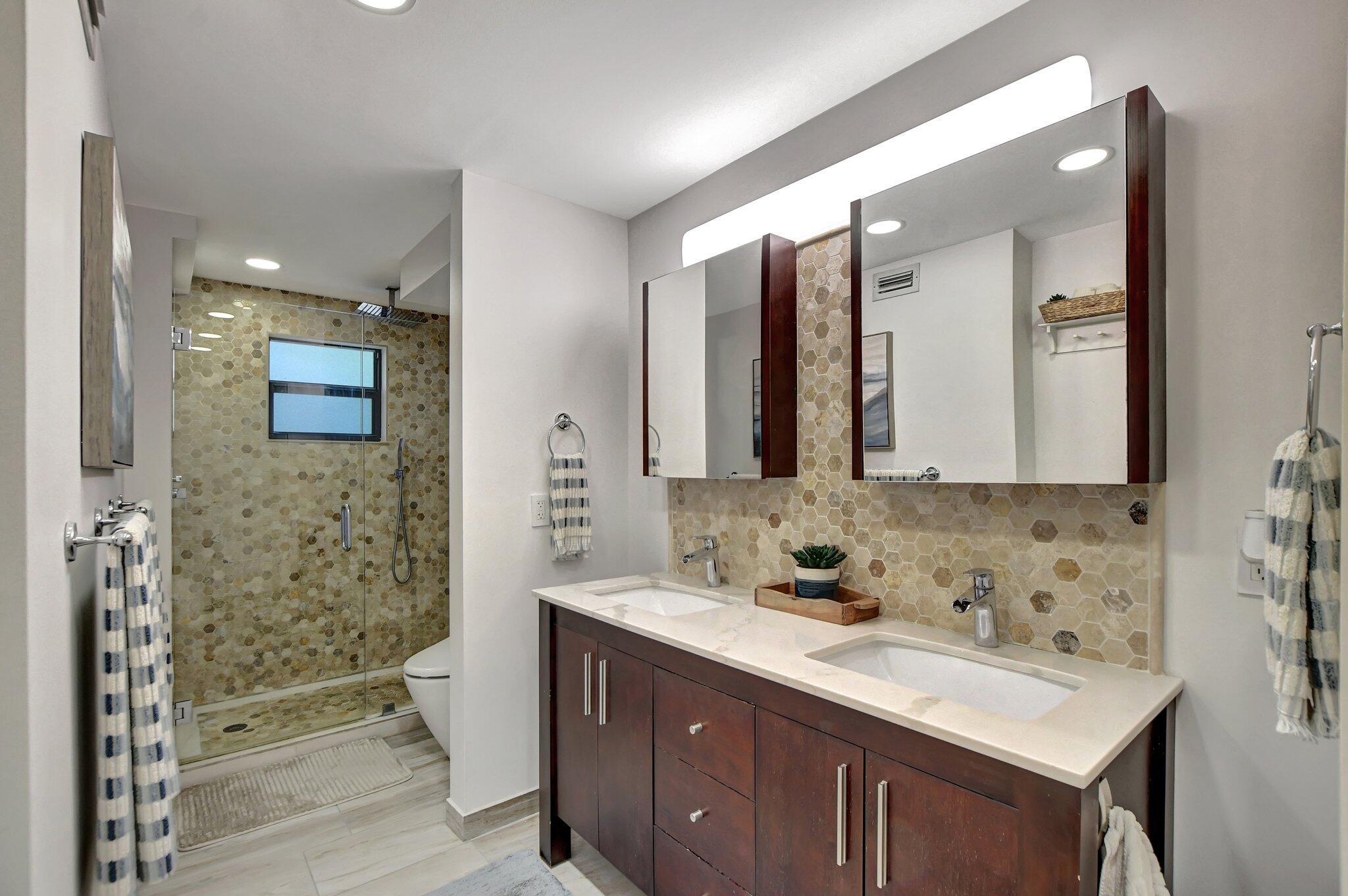 277 North Ocean Boulevard, Unit 3010 Boca Raton, FL 33432 - Photo 23 of 37 a bathroom with a sink a toilet and shower