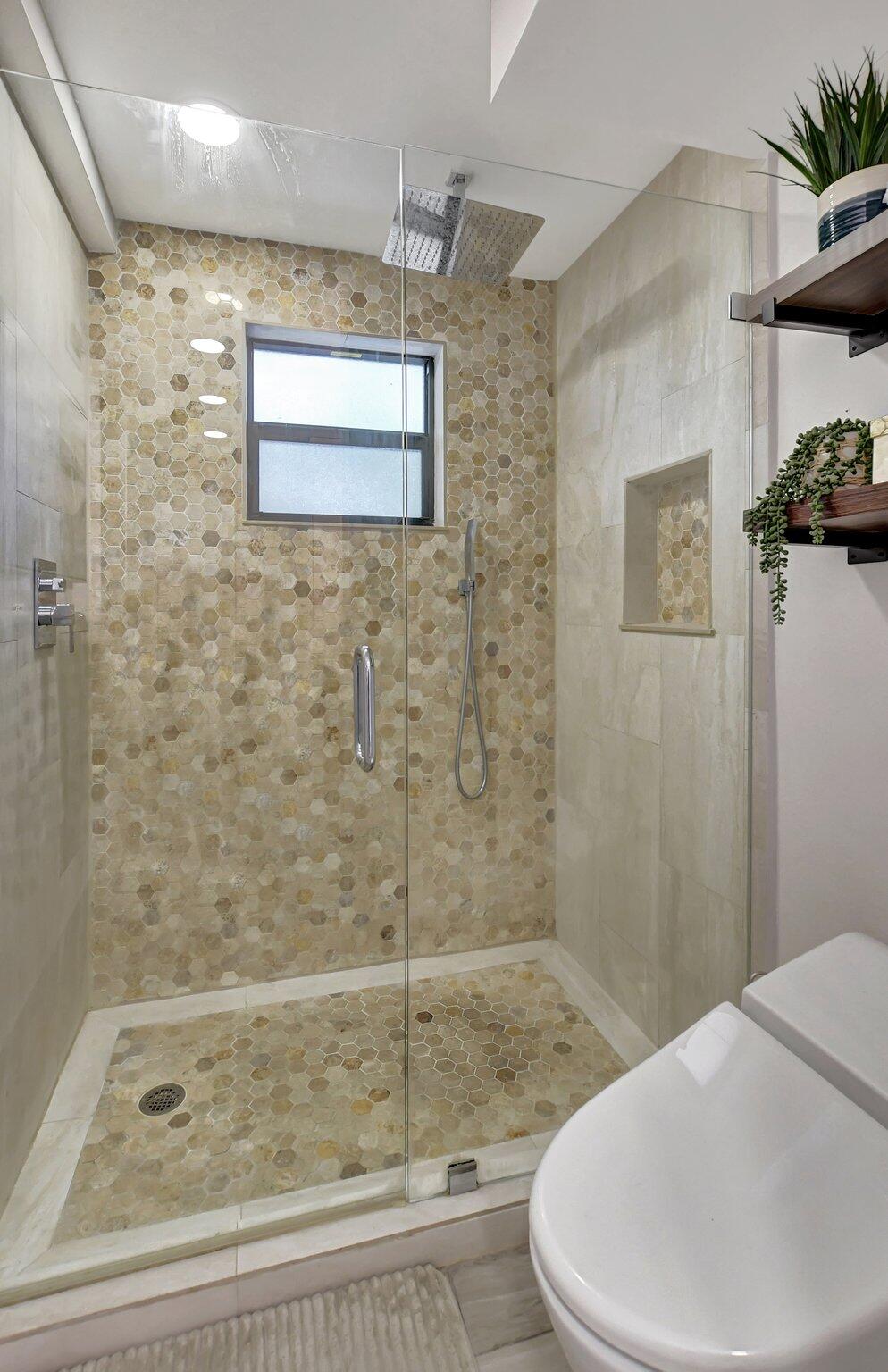 277 North Ocean Boulevard, Unit 3010 Boca Raton, FL 33432 - Photo 25 of 37 a bathroom with a bathtub and shower