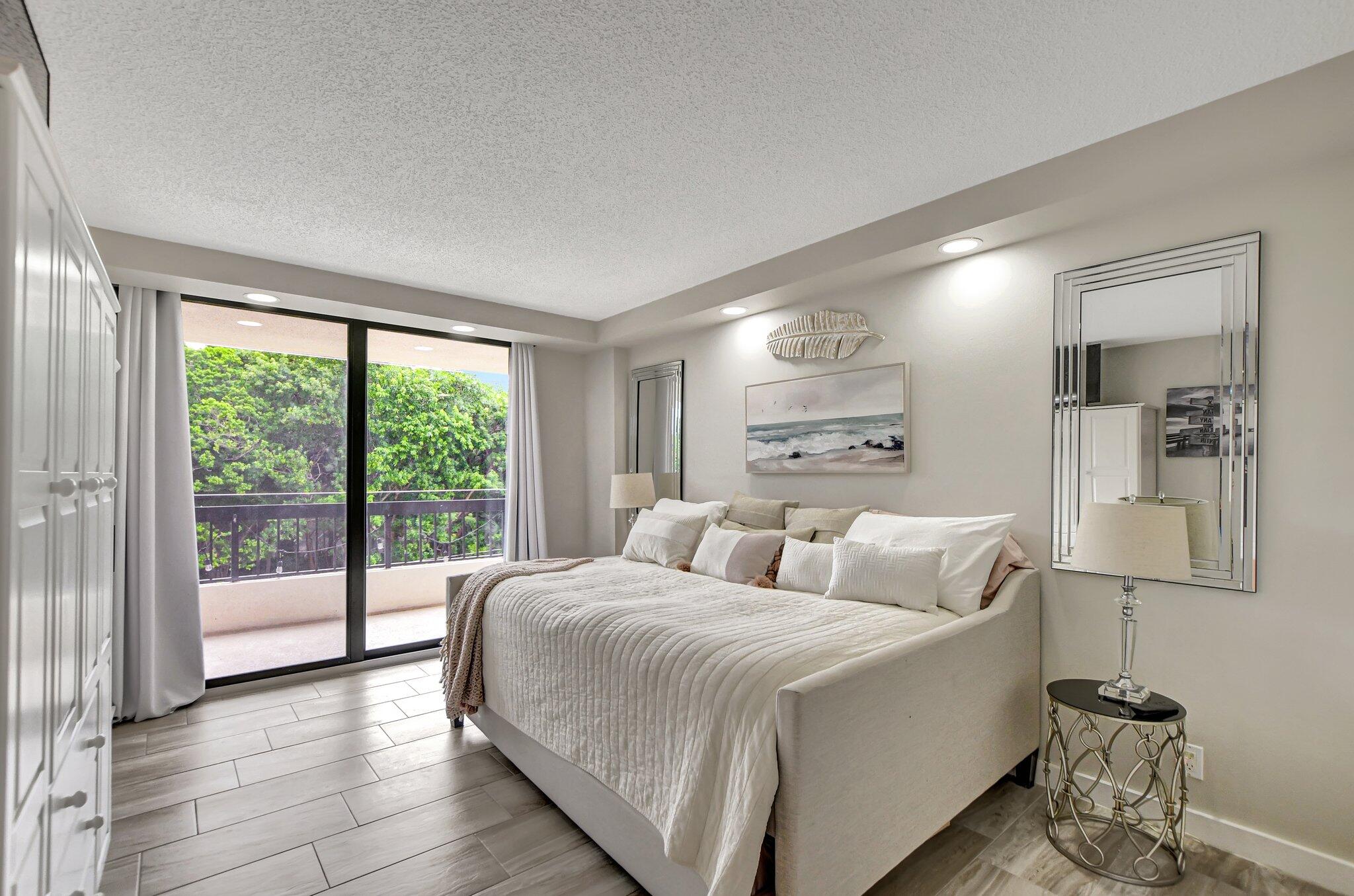277 North Ocean Boulevard, Unit 3010 Boca Raton, FL 33432 - Photo 27 of 37 a bedroom with a large bed and a large window