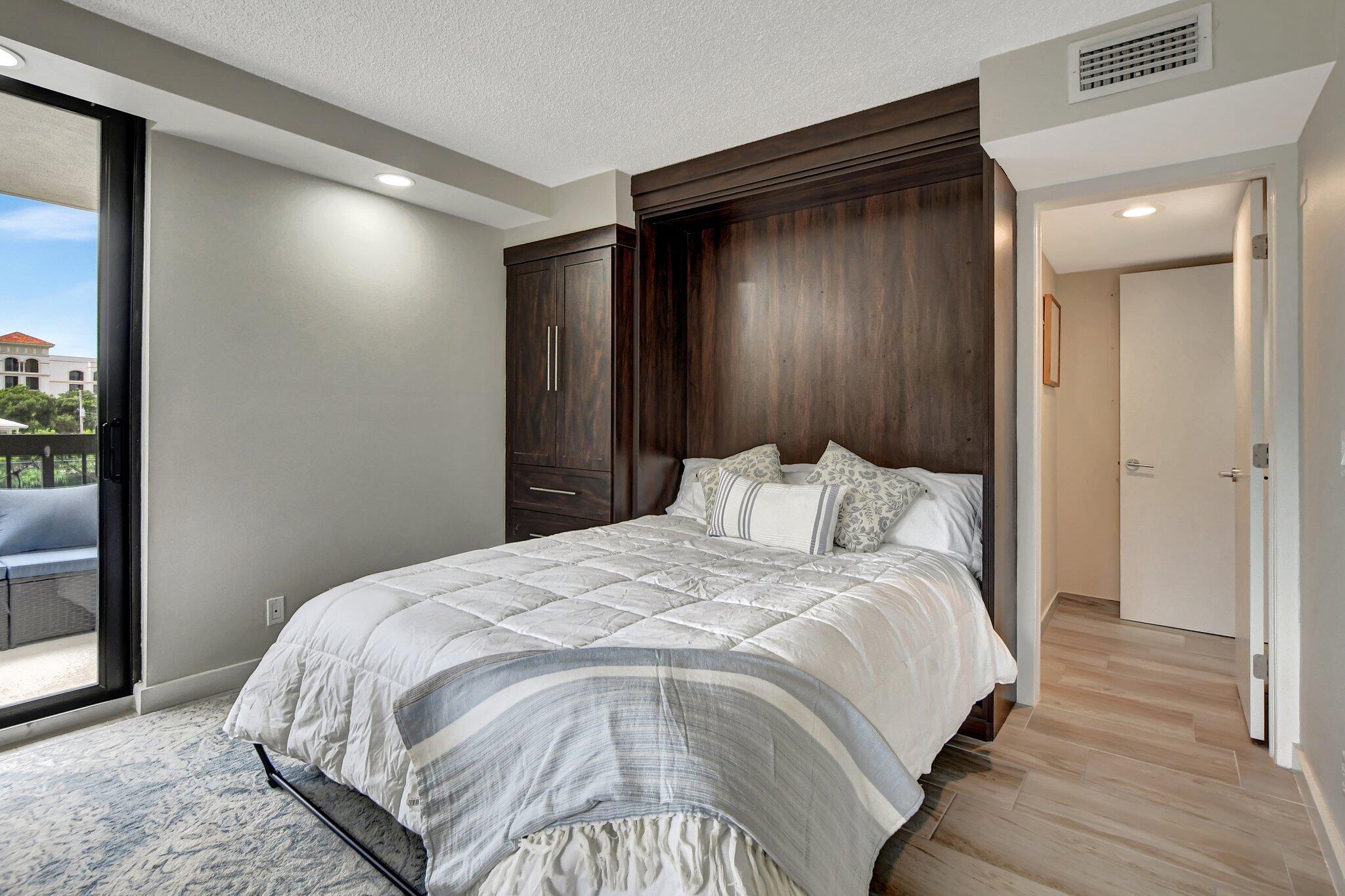 277 North Ocean Boulevard, Unit 3010 Boca Raton, FL 33432 - Photo 32 of 37 a bed sitting in a bedroom next to a bathroom