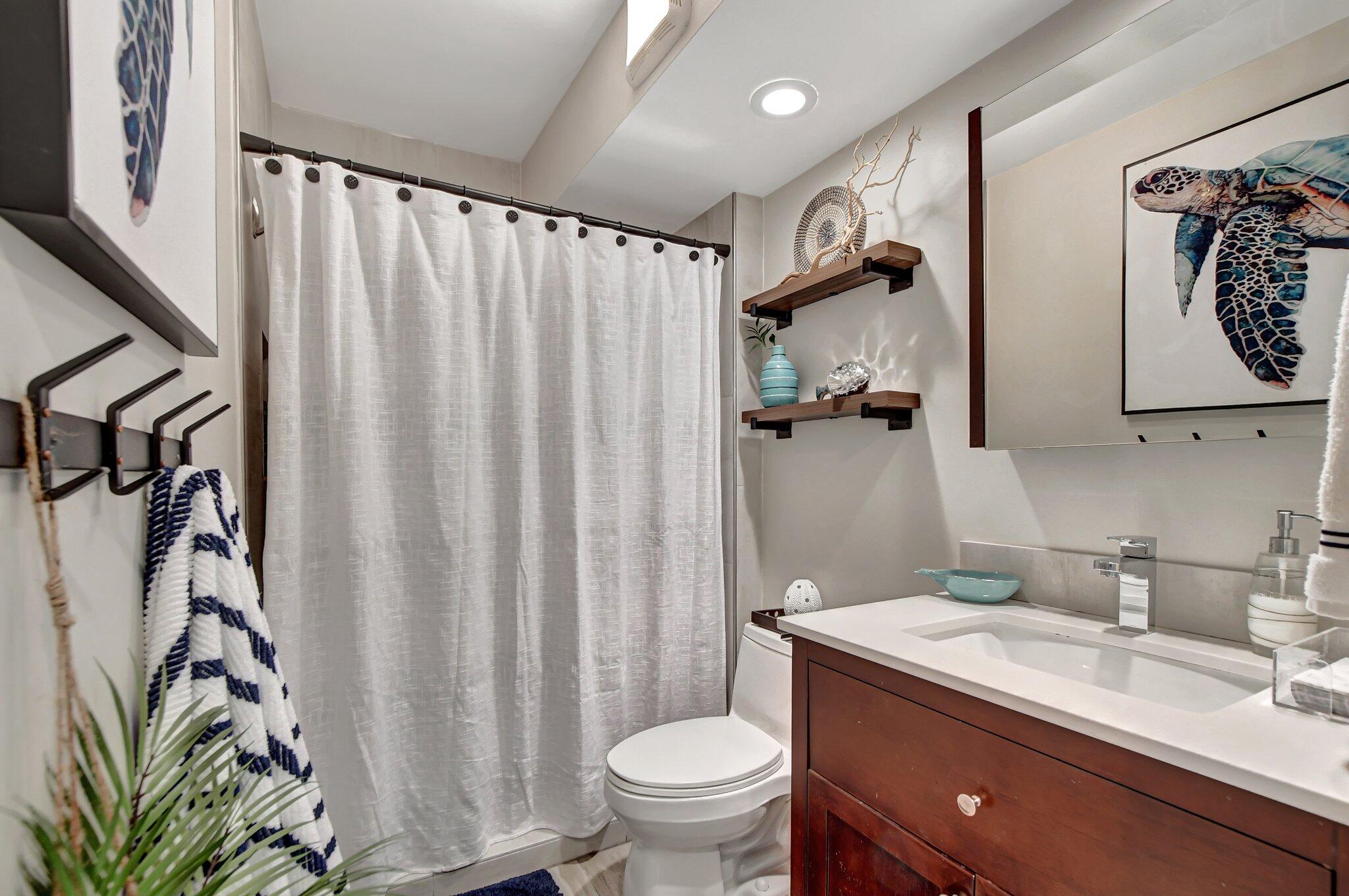 277 North Ocean Boulevard, Unit 3010 Boca Raton, FL 33432 - Photo 33 of 37 a bathroom with a granite countertop sink toilet and shower