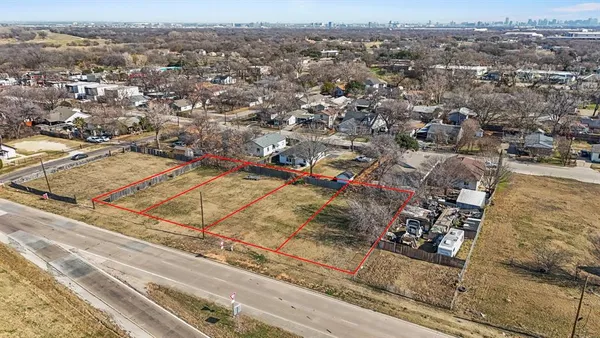an aerial view of residential houses with city view