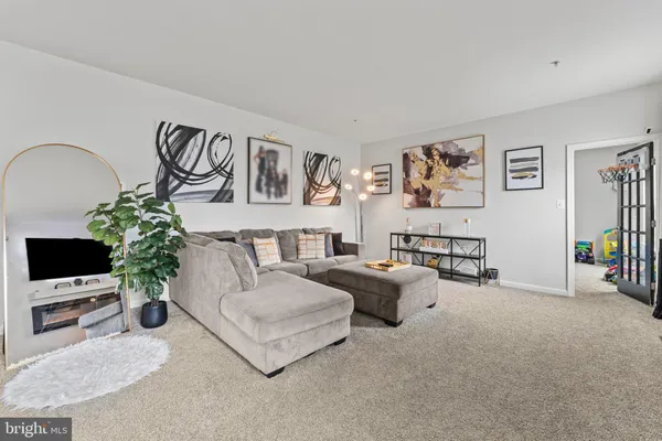 a living room with furniture and flowers