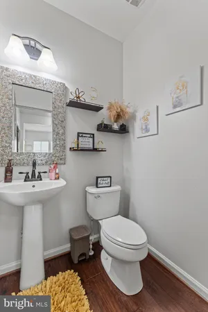 a bathroom with a toilet a sink and mirror