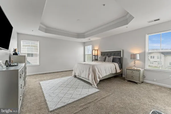 a bedroom with a bed and flat screen tv