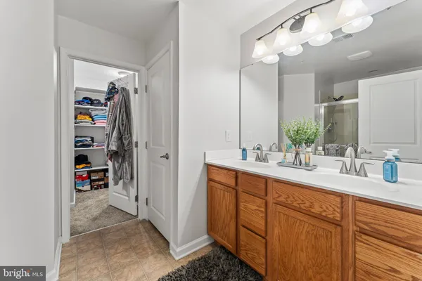 a bathroom with a double vanity sink a and a mirror