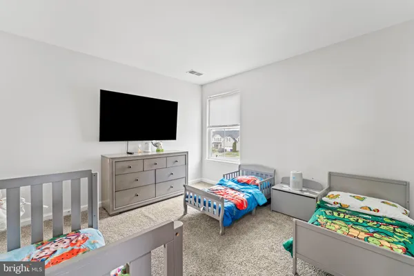 a bedroom with furniture and a flat screen tv