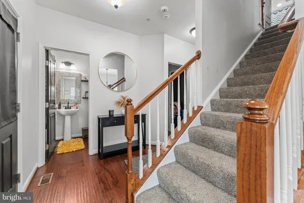 a view of entryway and hall with wooden floor