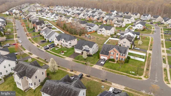 an aerial view of a residential houses with yard