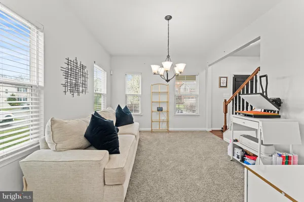 a living room with furniture and a chandelier