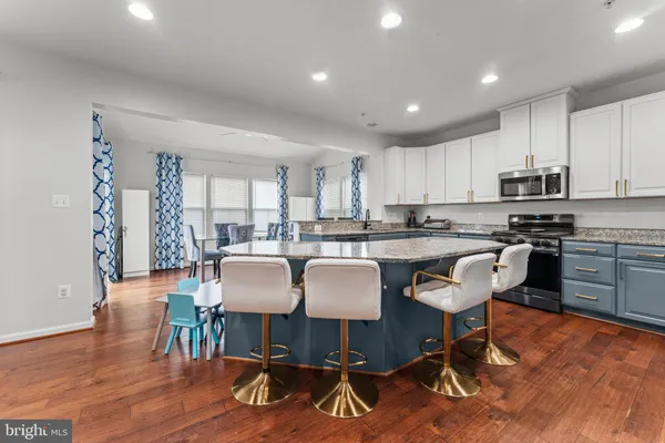 a view of kitchen with microwave and cabinets