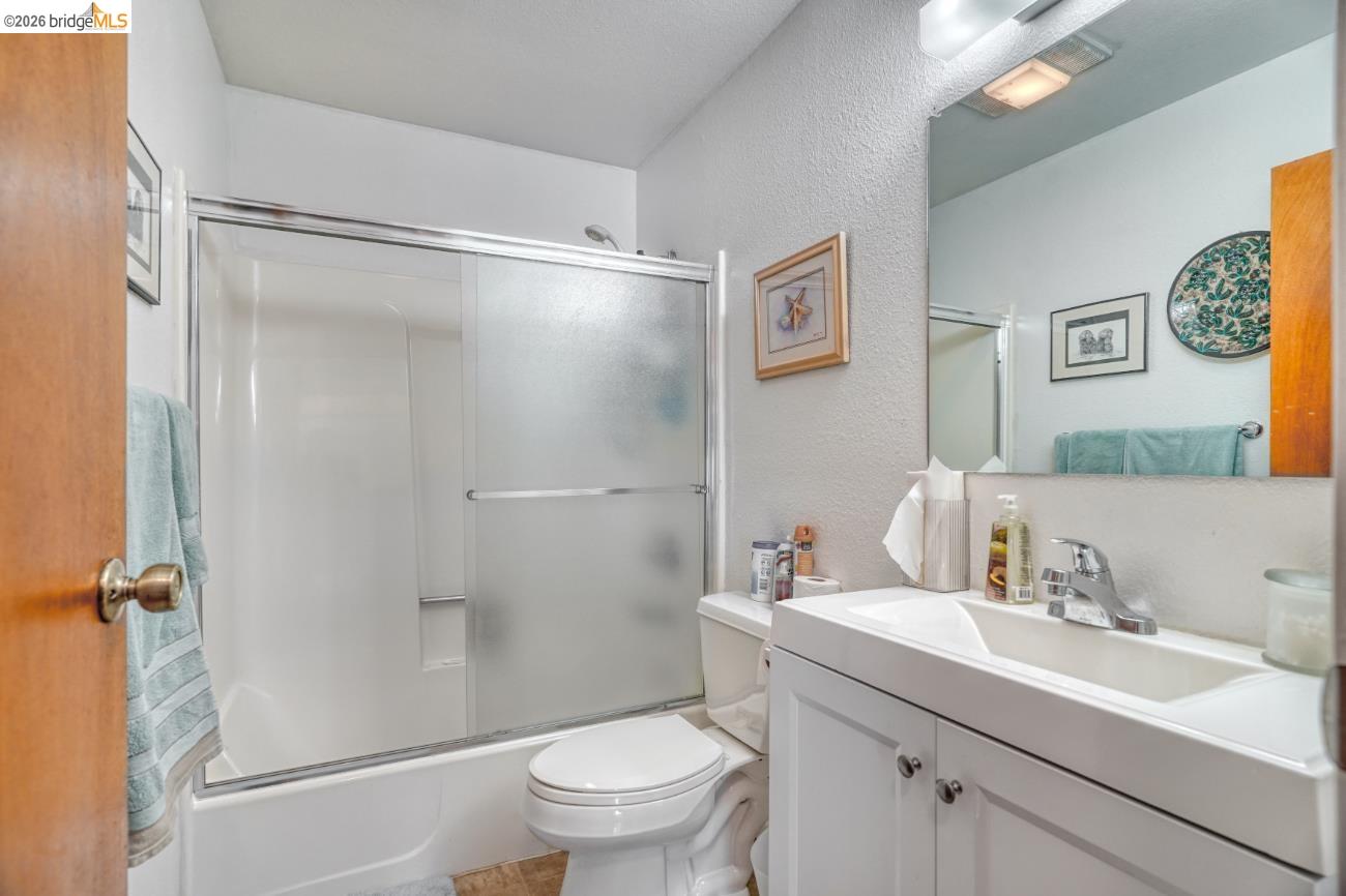19215 Ferretti Road Groveland, CA 95321 - Photo 15 of 40 Bathroom featuring a white vanity with integrated sink, chrome faucet, and mirrored medicine cabinet