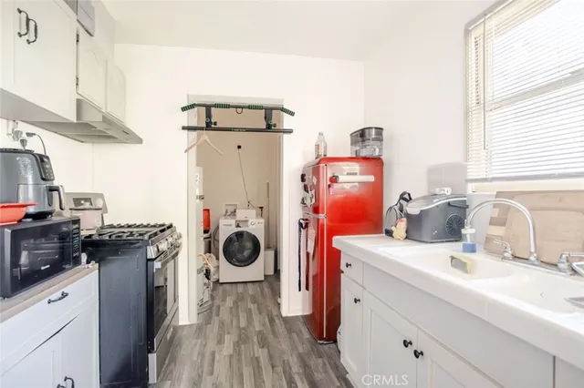 a kitchen with a refrigerator and a stove