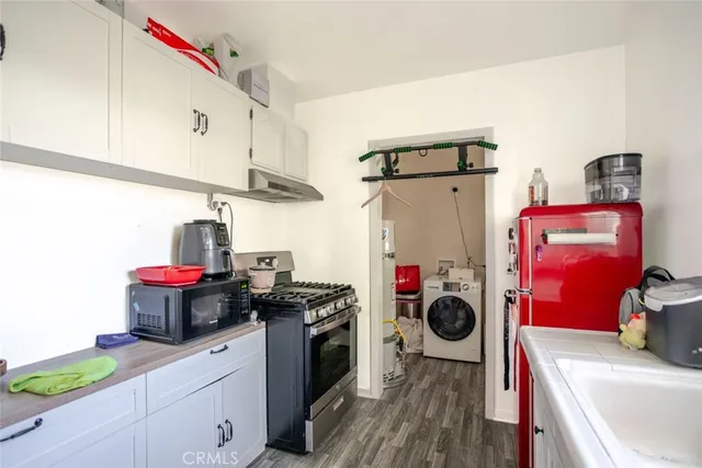 a kitchen with stainless steel appliances granite countertop a sink and a stove