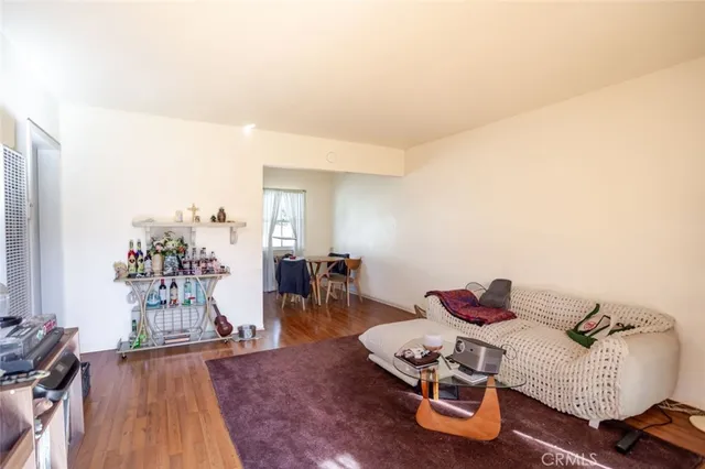 a bedroom with furniture and a wooden floor