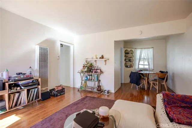 a living room with furniture a wooden floor and a window