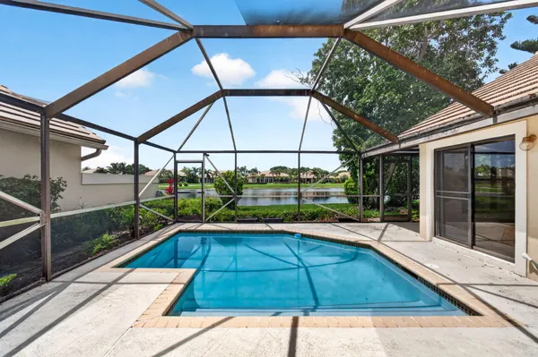 a view of a swimming pool with a yard
