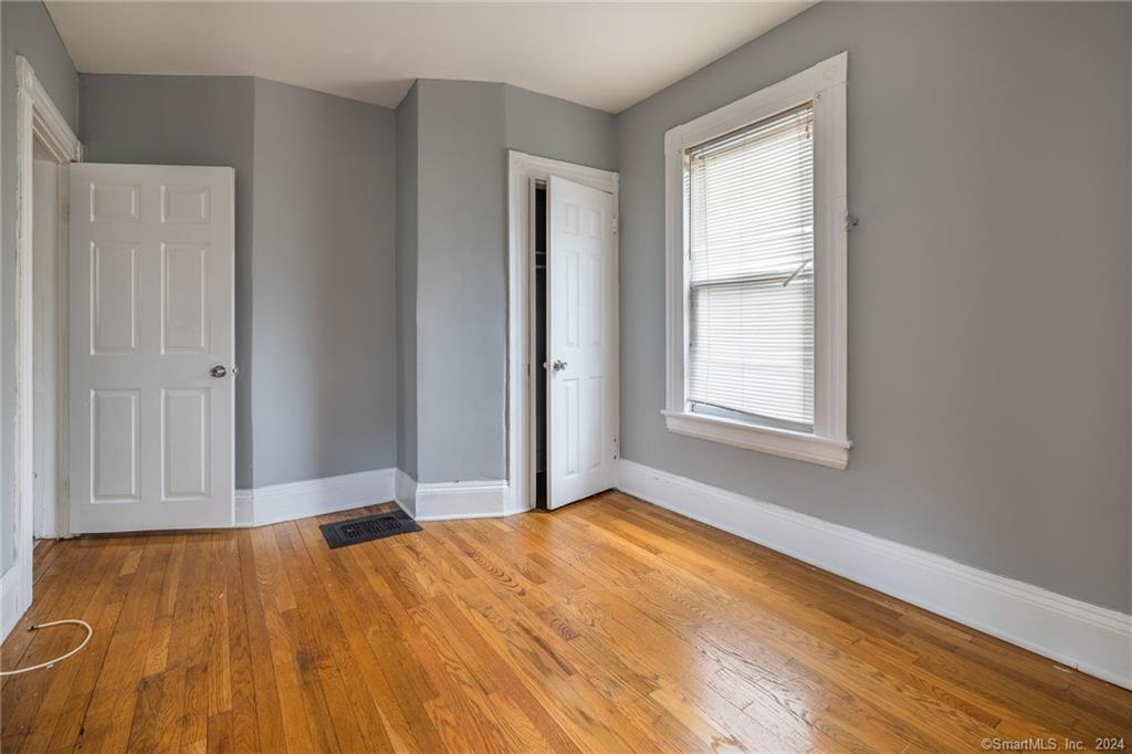 26 Pleasant Street Bridgeport, CT 06608 - Photo 11 of 15 a view of empty room with window and wooden floor
