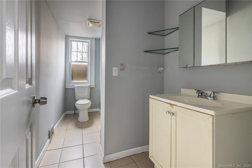 26 Pleasant Street Bridgeport, CT 06608 - Photo 8 of 15 a bathroom with a sink toilet and shower