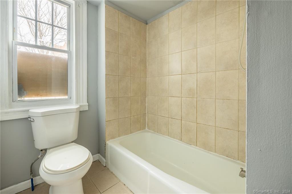 26 Pleasant Street Bridgeport, CT 06608 - Photo 9 of 15 a white toilet sitting next to a bath tub