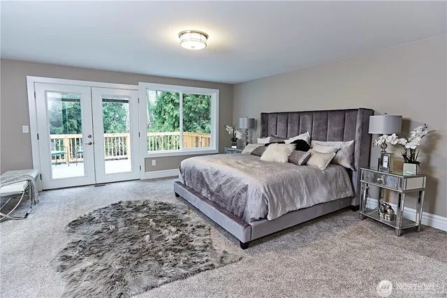 a spacious bedroom with a bed and a large window