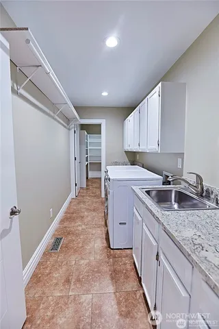 a kitchen with granite countertop a sink stove and refrigerator