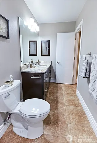 a bathroom with a toilet a sink and mirror