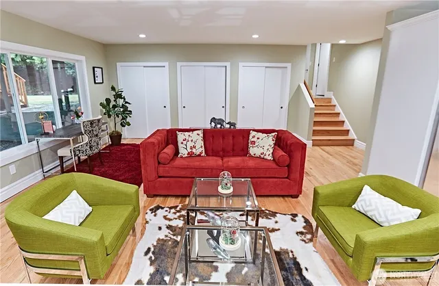 a living room with furniture and wooden floor