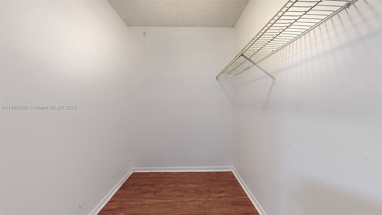 491 Ives Dairy Road, Unit 3055 Miami, FL 33179 - Photo 11 of 24 a view of a room with racks on the wall