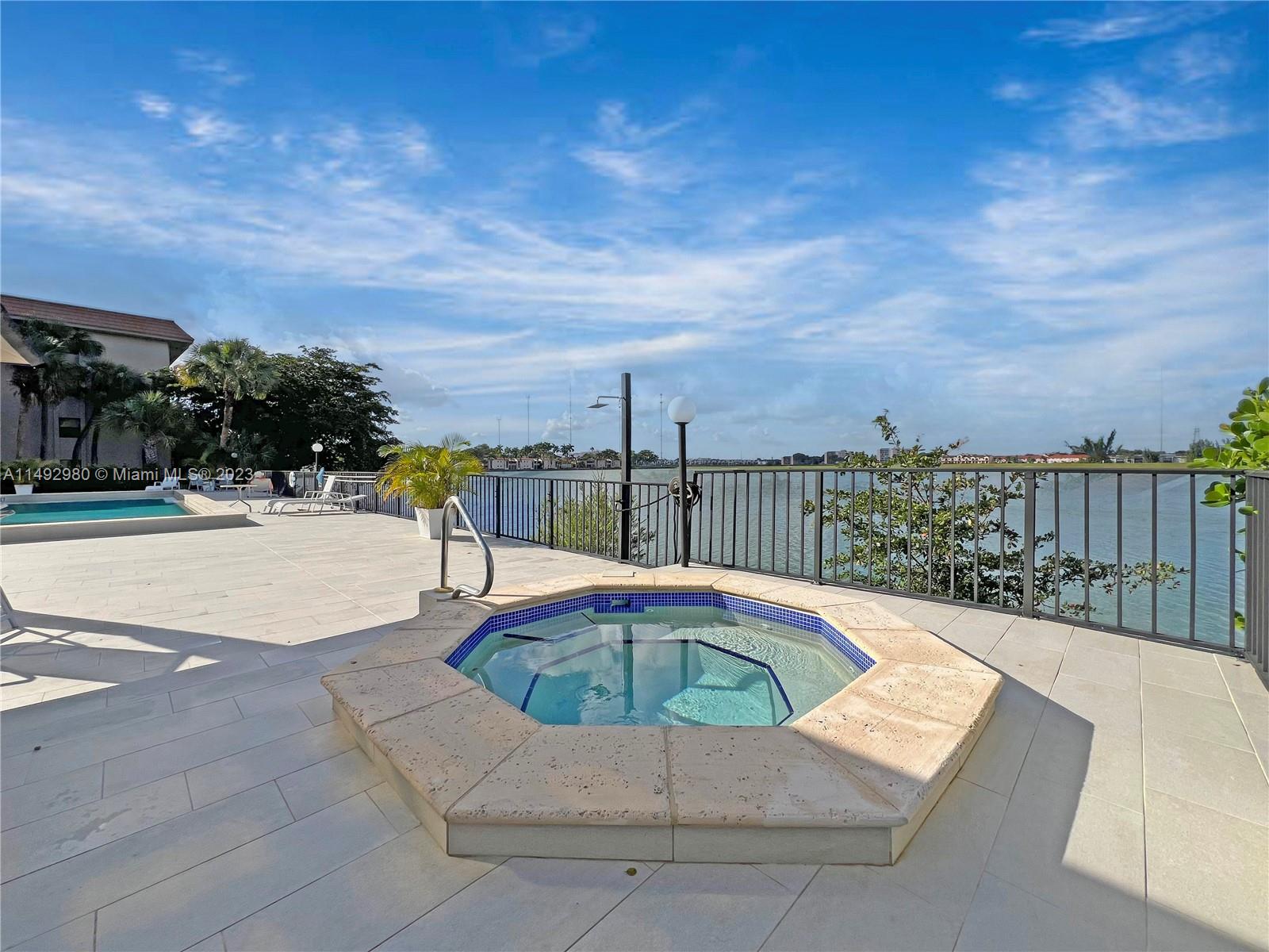 491 Ives Dairy Road, Unit 3055 Miami, FL 33179 - Photo 17 of 24 a view of a swimming pool with a patio