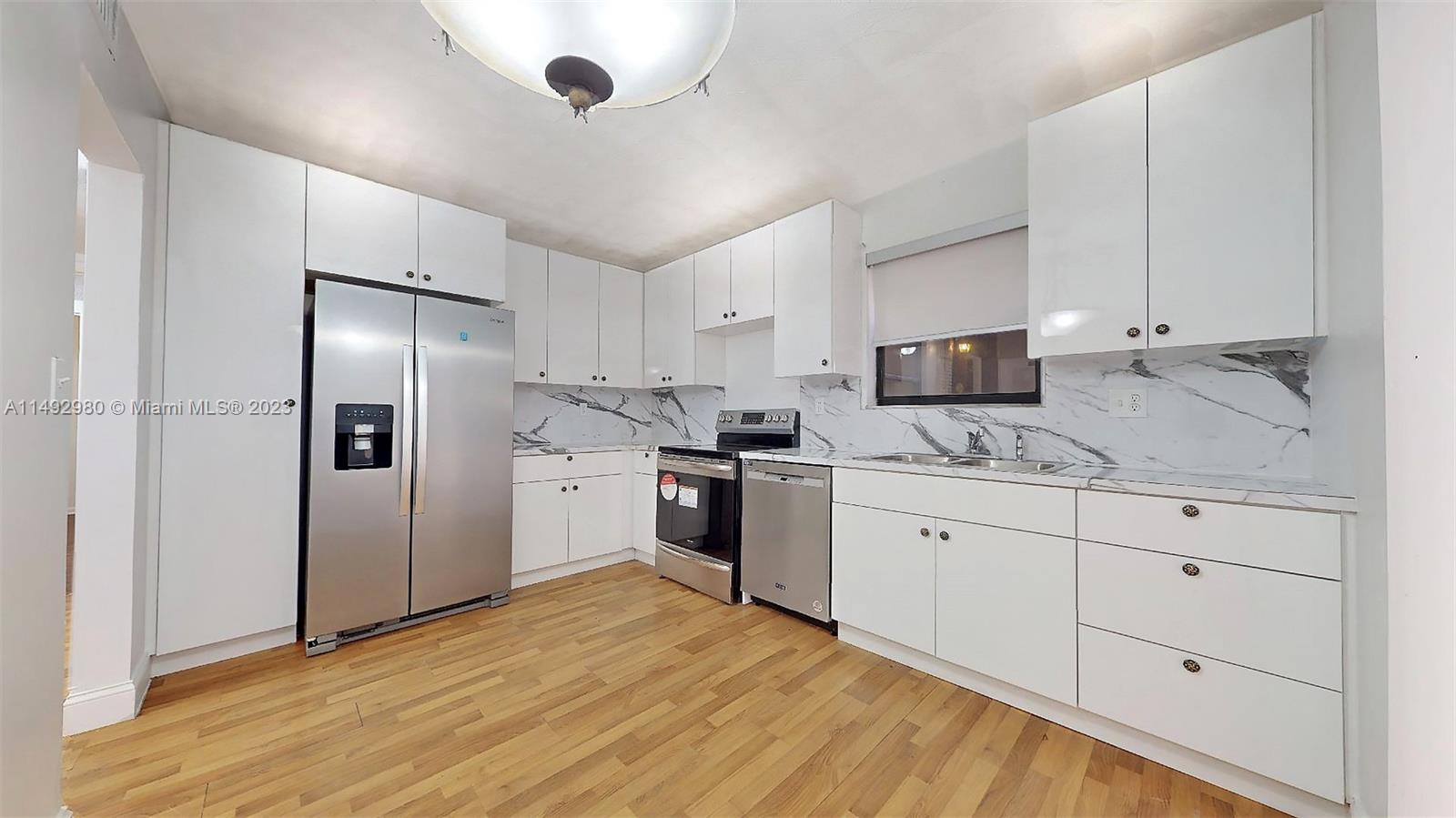 491 Ives Dairy Road, Unit 3055 Miami, FL 33179 - Photo 4 of 24 a kitchen with granite countertop a refrigerator stove and sink