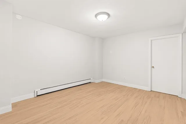 an empty room with wooden floor