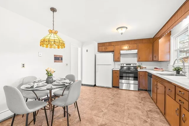 a kitchen with stainless steel appliances kitchen island granite countertop a sink a stove and a refrigerator